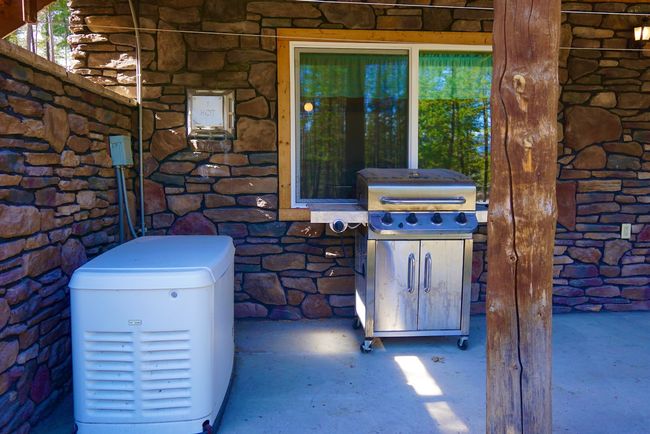 Details with stone siding and a power unit | Image 16