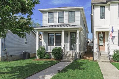 Exterior soft colors combine with bold accents to create a warm welcome to 6116B California Avenue. Love the beautiful Maple tree and lush lawn! The side walk brings your guests straight to the beautiful front door! | Image 1