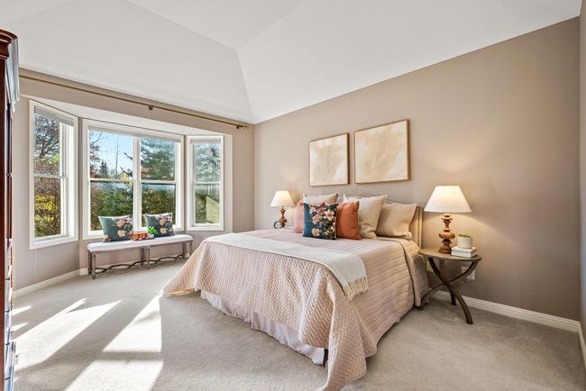 Primary bedroom with beautiful bay window overlooking picturesque view of a stunning wooded lot. | Image 17