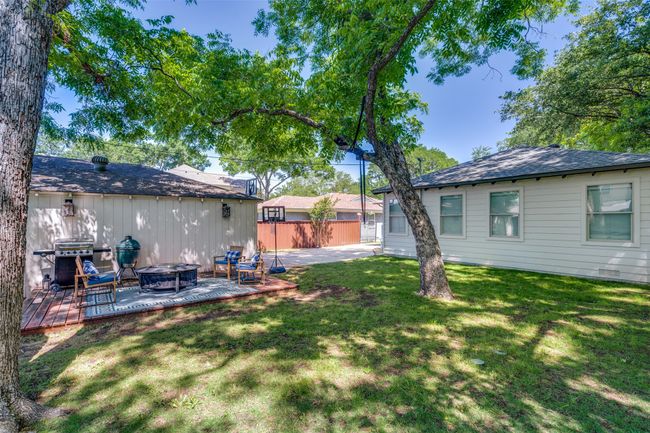 View of yard with an outdoor fire pit and a patio area | Image 23