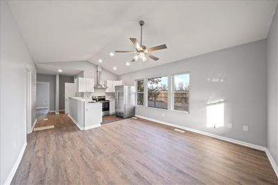 Kitchen with appliances with stainless steel finishes, wood-type flooring, lofted ceiling, and ceiling fan | Image 3