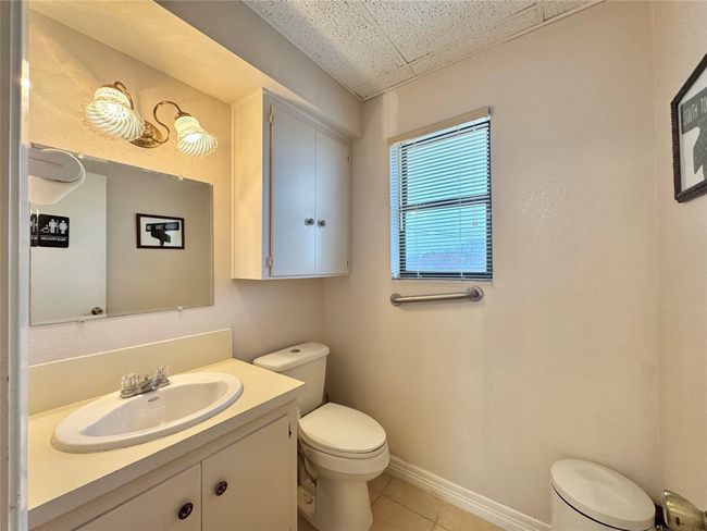 Bathroom with vanity, tile patterned flooring, and toilet | Image 37