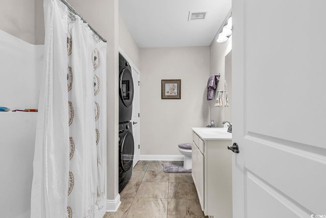 Bedroom with wood finished floors, baseboards, and ceiling fan | Image 8