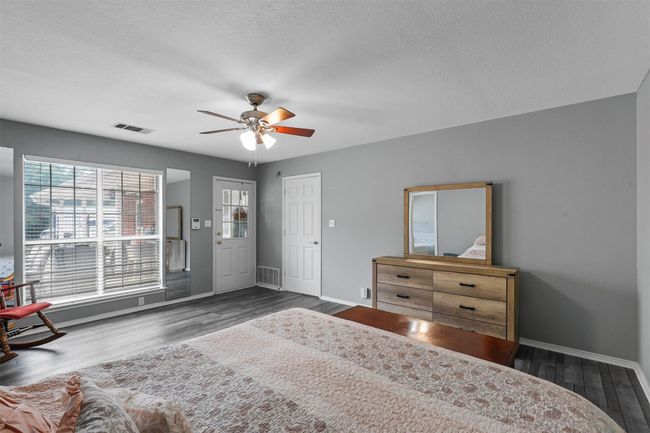 Bedroom featuring a textured ceiling, dark hardwood / wood-style floors, and ceiling fan | Image 23