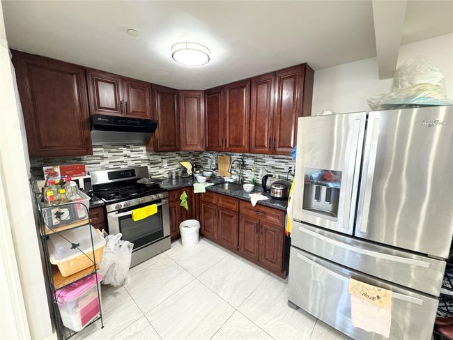 Kitchen with sink, decorative backsplash, and appliances with stainless steel finishes | Image 5