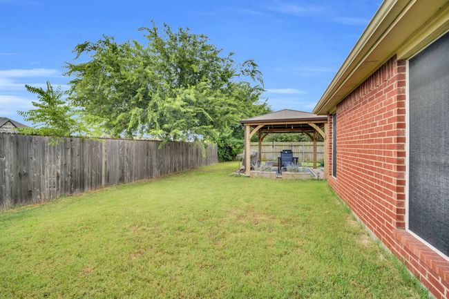 Fenced backyard featuring a gazebo | Image 36