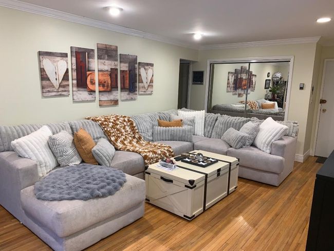 Living room with oak flooring, recessed lighting, and crown molding and an oversized double coat closet | Image 4