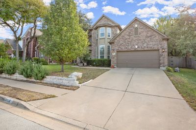 Nestled on a low-traffic street in the highly desirable Ranch At Deer Creek community, this well-maintained 2-story home boasts great curb appeal with a brick exterior, lush landscaping, and a welcoming covered front porch on an oversized .207-acre lot. | Image 2