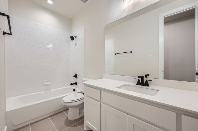 Bathroom featuring toilet, vanity, shower / bathtub combination, tile patterned flooring, and recessed lighting | Image 24