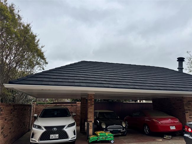 View of parking with a carport and fence | Image 4