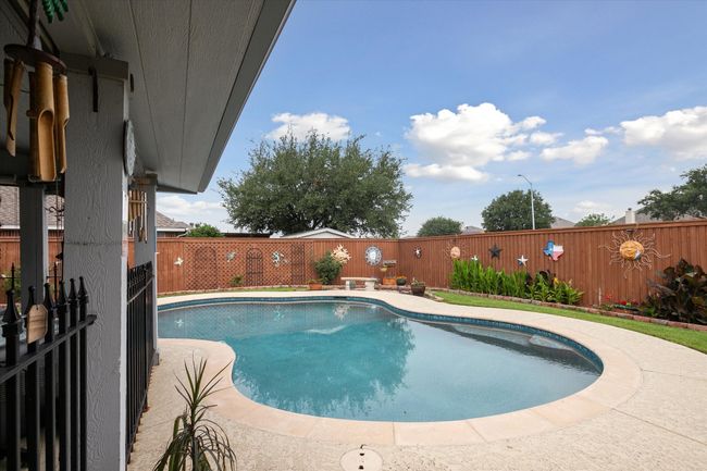 View of swimming pool featuring a fenced backyard | Image 30