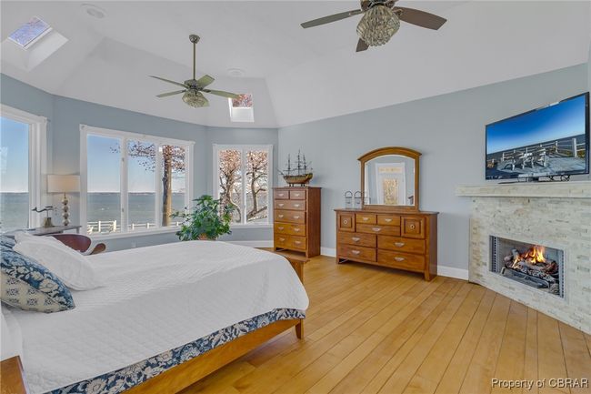 1st floor primary bedroom with gas fireplace. | Image 22