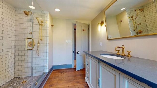 Bathroom featuring walk in shower, hardwood / wood-style flooring, and vanity | Image 27