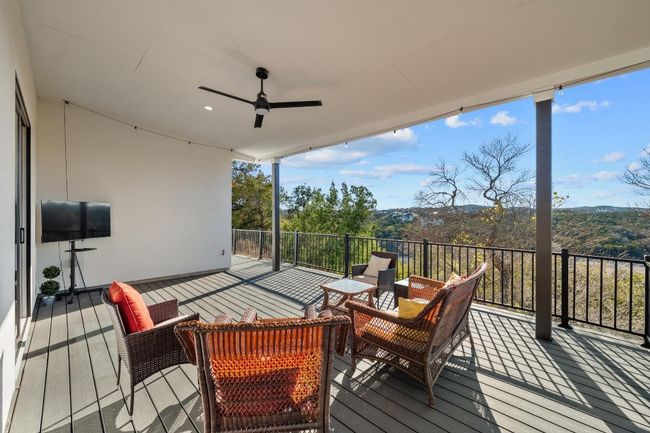 A captivating balcony offers a front-row seat to breathtaking panoramic views of the Hill Country, providing the perfect setting to relax, unwind, and take in the beauty of the surroundings. Thoughtfully designed for both elegance and comfort, this outdoor retreat enhances the home’s seamless connection to nature. | Image 33