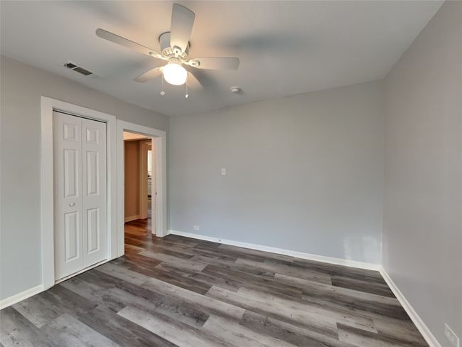 Unfurnished bedroom featuring baseboards, dark wood finished floors, and a closet | Image 5