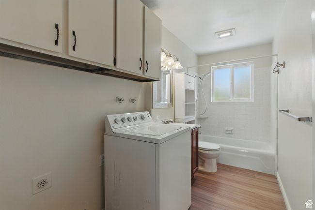 Laundry area featuring light wood finished floors, laundry area, and washer / dryer | Image 11