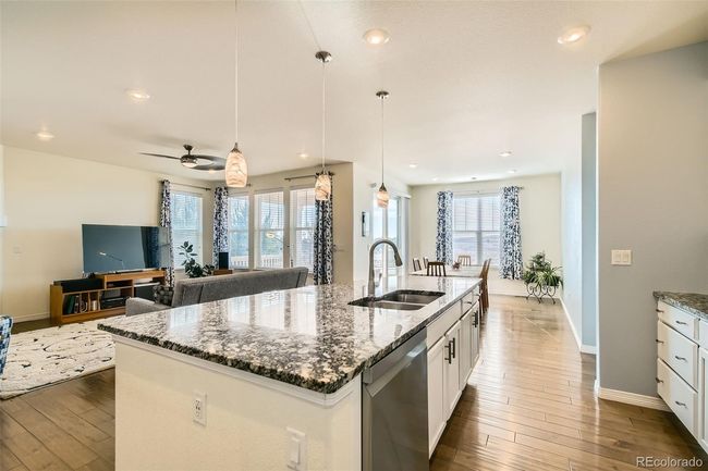 Open concept kitchen with a large island storage pantry. | Image 4