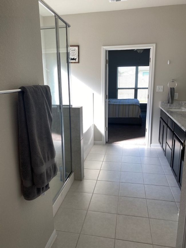 Bathroom featuring a shower stall, ensuite bath, vanity, tile patterned flooring, and a garden tub | Image 20