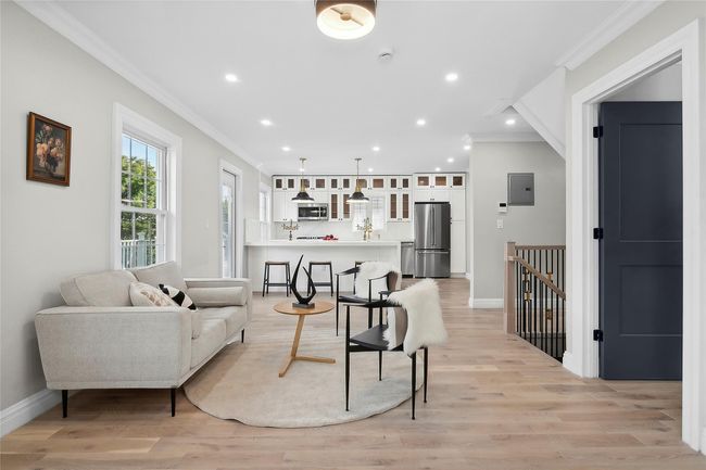 Living area with crown molding, recessed lighting, light wood finished floors, and electric panel | Image 4