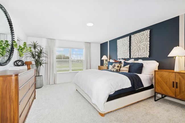 (Photo of model home, features will vary) Nestled on the top floor, the private owner’s suite boasts a spacious bedroom to provide restful nights and a tranquil haven for relaxation, complemented by an en-suite bathroom and large walk-in closet. | Image 10