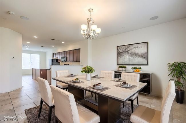 Dining area featuring light tile patterned floors, visible vents, a notable chandelier, and recessed lighting **VIRTUALLY STAGED** | Image 4