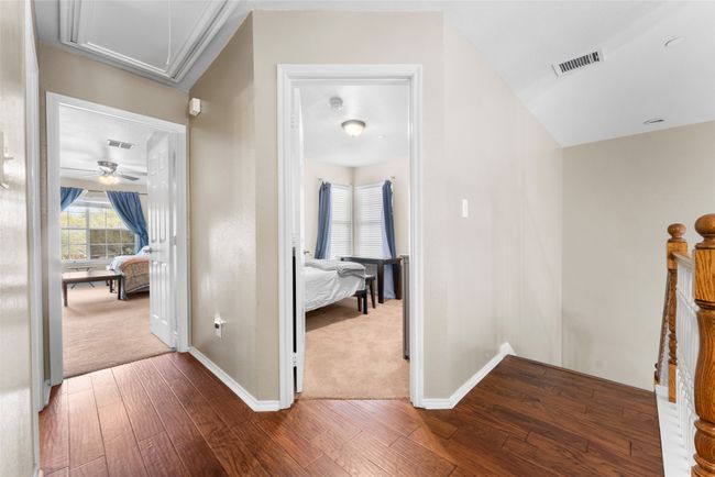 Hall with attic access, baseboards, visible vents, and dark wood finished floors | Image 20