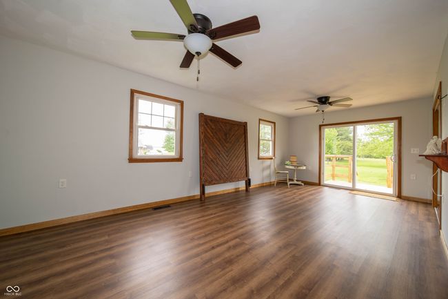 spare room with ceiling fan, baseboards, and wood finished floors | Image 21