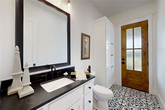 Bathroom with vanity, toilet, baseboards, and tile patterned floors | Image 26