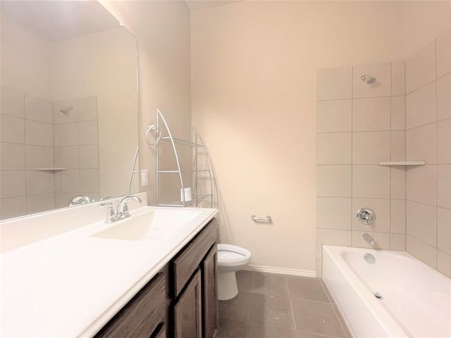 Bathroom with vanity, tile patterned floors, and tub / shower combination | Image 16