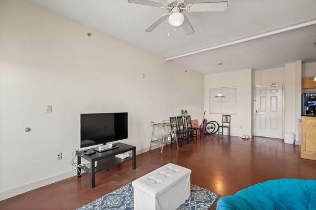 Living room with a ceiling fan and baseboards | Image 13