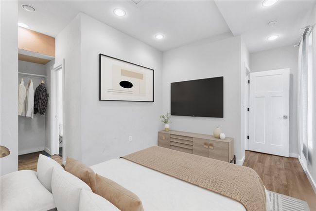 Bedroom with wood finished floors and recessed lighting | Image 28