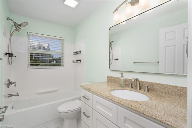 Bathroom featuring marble tile finish floor, toilet, shower / bathtub combination, and vanity. | Image 11