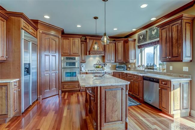 Chefs dream kitchen with maple cabinets, Brazilian Cherry floors, stainless steel appliances, and granite countertops | Image 17