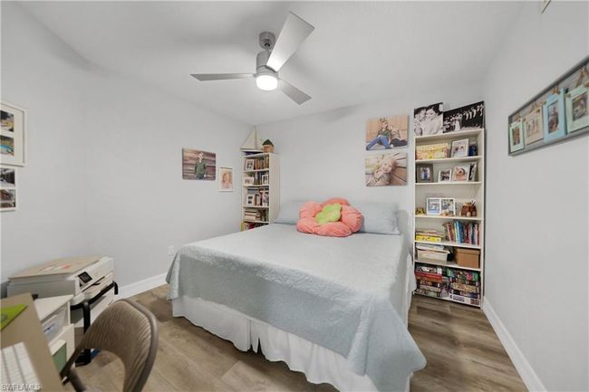 Bedroom with ceiling fan and hardwood / wood-style flooring | Image 35