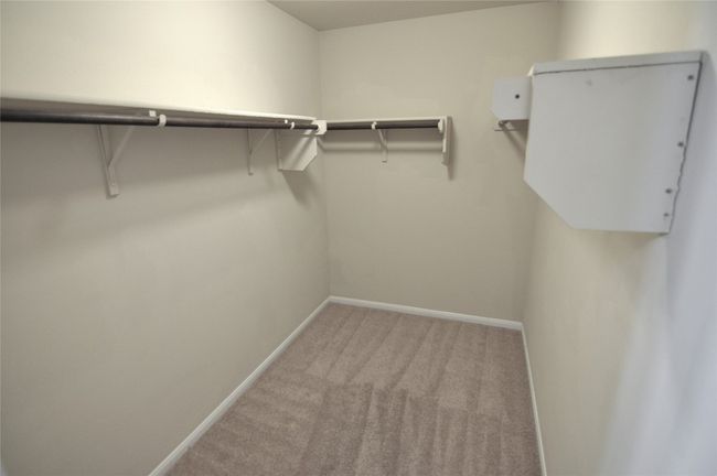 Walk in closet with light carpet | Image 19