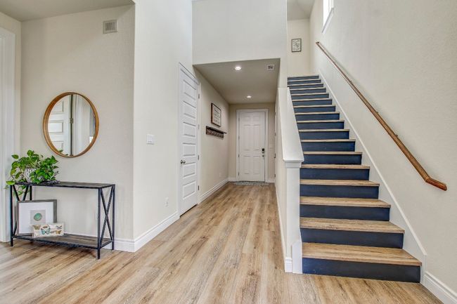 Stairway with wood finished floors, recessed lighting, and a high ceiling | Image 24
