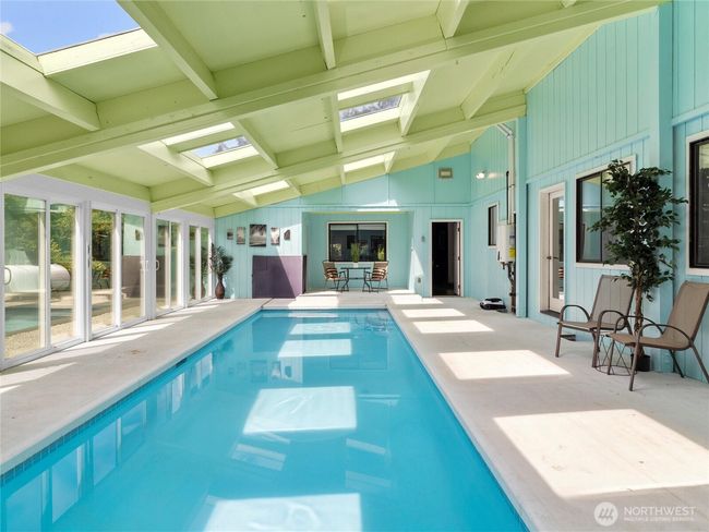 Enjoy resort-style living with an indoor heated pool enclosed in a stunning solarium. | Image 25