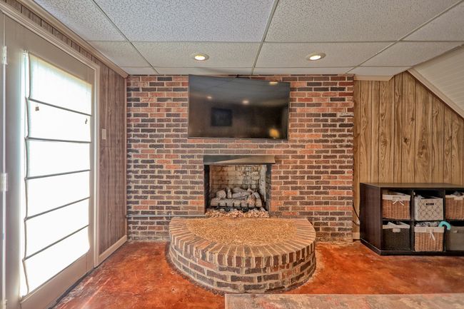 Fireplace with gas logs and large hearth. | Image 26