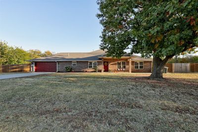 Ranch-style home with a garage and a front lawn | Image 3