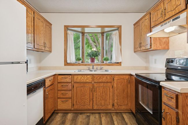 A mature tree offers shade and a serene view out of the kitchen window. | Image 10