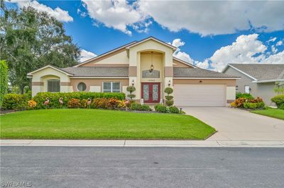 View of front facade with a garage and a front yard | Image 1