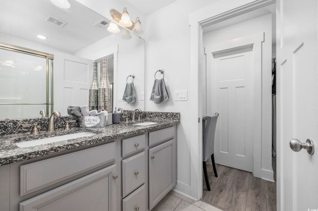Full bathroom featuring visible vents, a sink, and a shower stall | Image 32