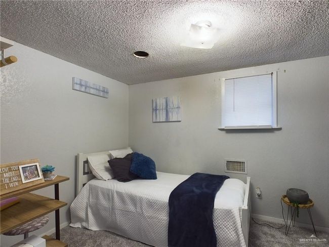 Bedroom featuring a textured ceiling and carpet | Image 20
