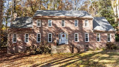 Colonial inspired home with a front lawn | Image 1