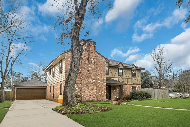 2 car garage with a long private driveway. | Image 4
