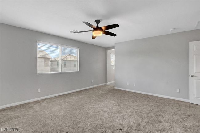 Carpeted spare room with a ceiling fan, healthy amount of natural light, and baseboards | Image 42