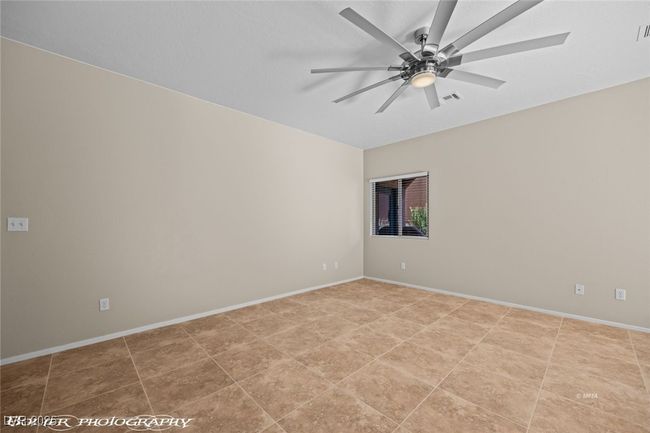 Spare room with baseboards, visible vents, and ceiling fan | Image 4