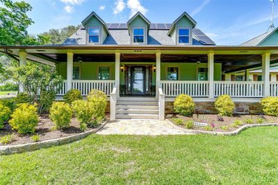 View of front of home featuring a front lawn, a porch, and ceiling fan | Image 3