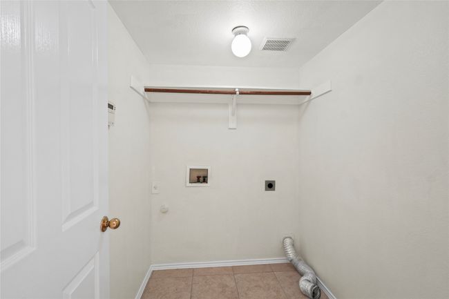 Clothes washing area featuring visible vents, laundry area, light tile patterned flooring, electric dryer hookup, and washer hookup | Image 10