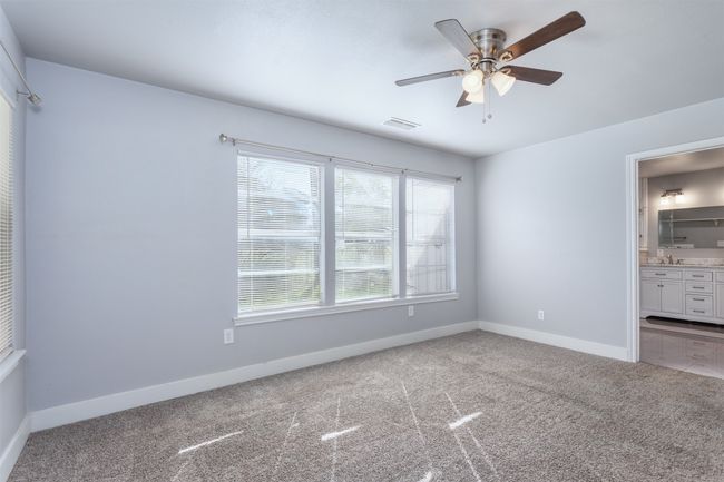Unfurnished bedroom with baseboards, visible vents, a sink, and carpet floors | Image 14